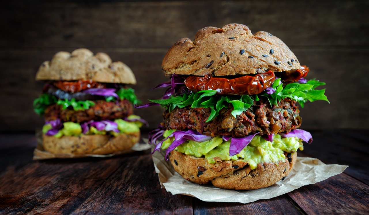 Plant based burgers dressed with lettuce and sun dried tomatoes