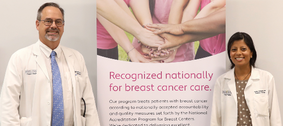 Physicians at Greater Heights Cancer Center pose with new banner.