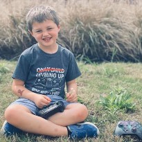 patient landon sitting on grass