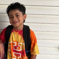 patient ivan smiling with backpack