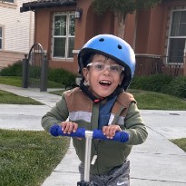 patient zayn riding scooter smiling