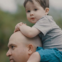 Dominic on his father's shoulders
