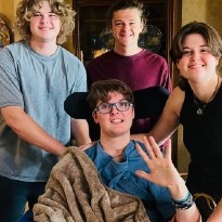 TIRR Memorial Hermann patient, Davis Coker, smiles with his siblings.