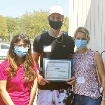 Sam Mills, LifeFlight patient, stands amongst families and clinicians after care with Memorial Hermann.