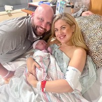 patient posing with newborn in hospital bed