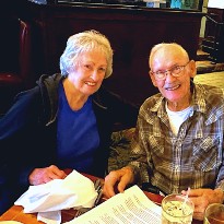 Cancer survivor, Deanna Owens smiles with her husband on a dinner date. 