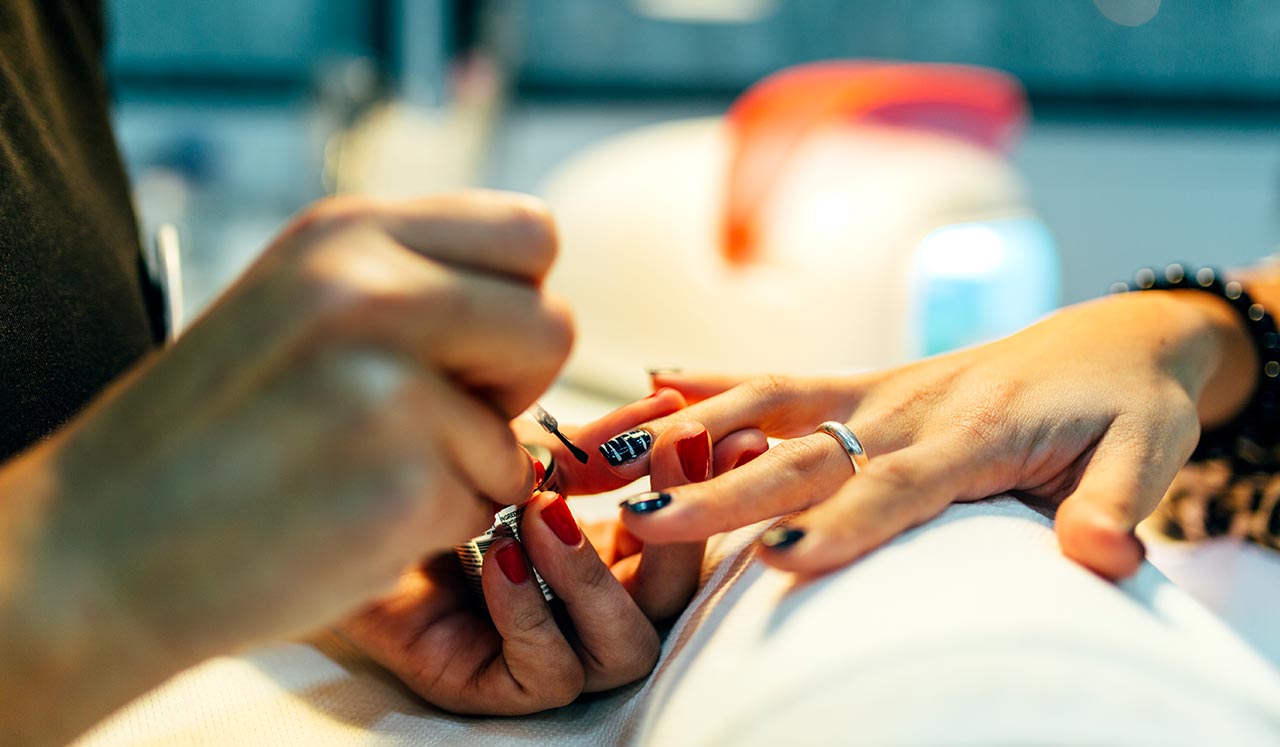 A woman having her nails painted