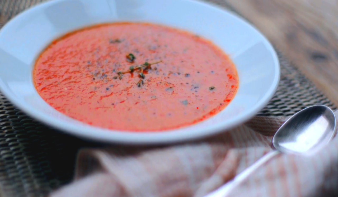 A bowl filled with vibrant tomato soup.