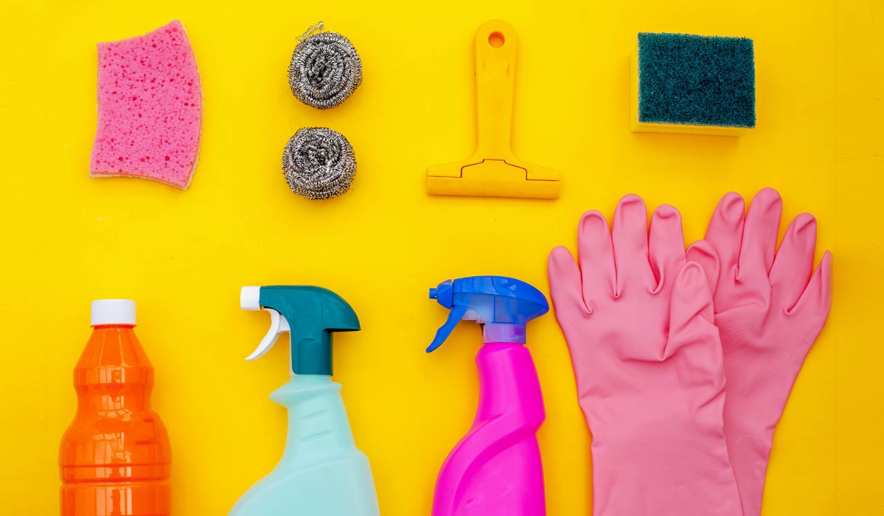 Pink rubber gloves and cleaning supplies