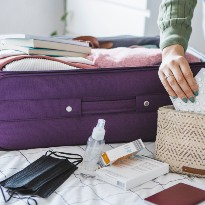 Person packing suitcase for trip