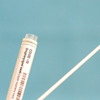 A medical swab and container for a COVID test.