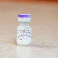 A vial of the Pfizer vaccine, fresh out of the freezer.