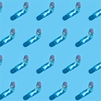 Vaccine vials arranged in a pattern on a blue background