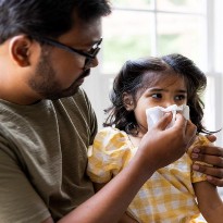 Parent helping sick child