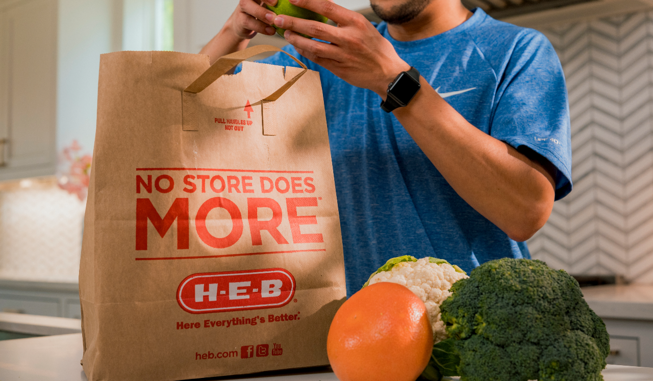 Person with HEB grocery bag