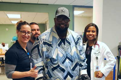 Memorial Hermann Rehabilitation Hospital - Katy patient, Anthony, stands strong with his care team.
