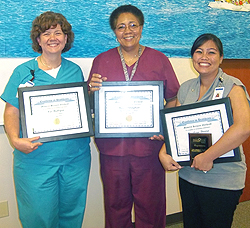 three women with awards