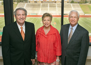 Three people at football field in Huntsville