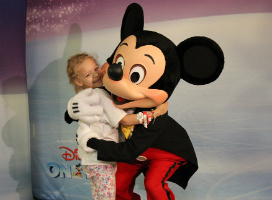 Child hugging Mickey Mouse