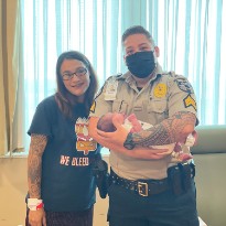 Morgan Lee and baby with Security Officer