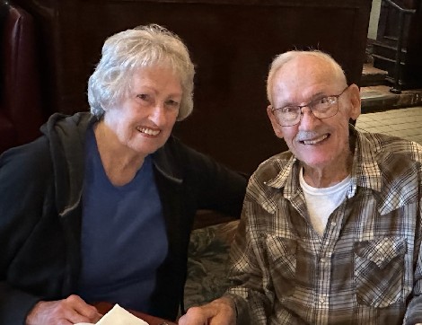 Cancer survivor, Deanna Owens smiles with her husband on a dinner date.