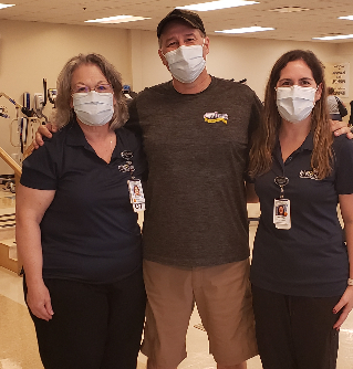 Brad Tippit takes a photograph with his Ops team at TIRR Memorial Hermann.