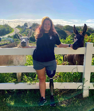 TIRR Memorial Hermann patient, Brook Toussaint, poses with two adorable donkeys.