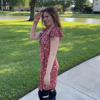 TIRR Memorial Hermann patient, Kelli Bixler, smiles in the shade on a sunny day.