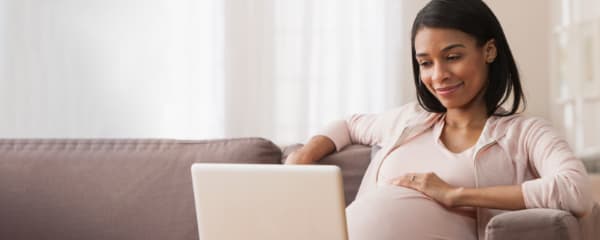 Pregnant women at computer