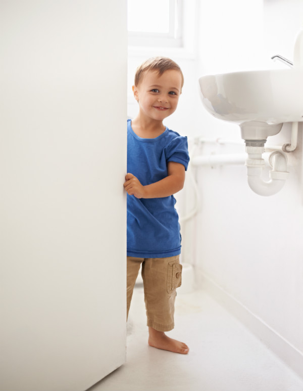 Child standing in bathroom
