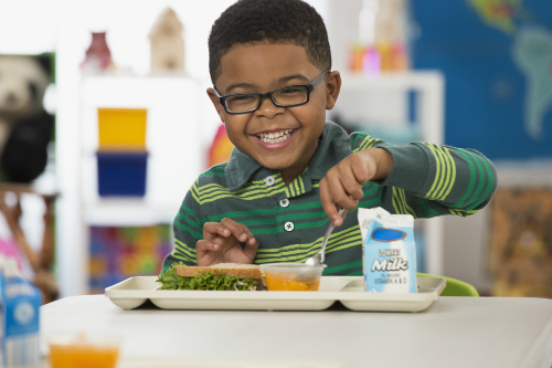 Child smiling and eating food