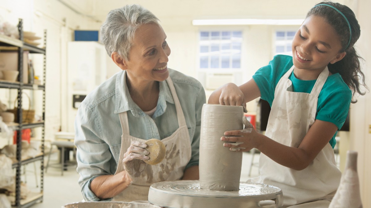 granddaughter and grandmother doing pottery together
