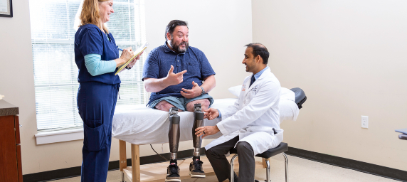 TIRR Memorial Hermann patient, Alex, discusses osseointegration with his physician and physical therapist.