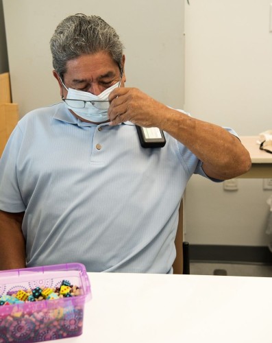 TIRR Memorial Hermann rehabilitation patient removes glasses during therapy session. 