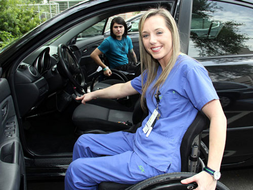 Emily Potter in wheel chair getting into car