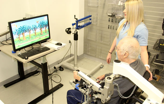 Man using rehabilitation machine with computer