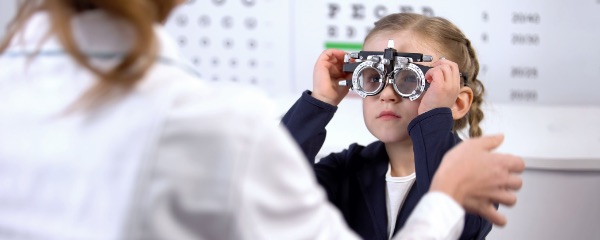 Doctor checking child's eyes