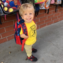 TIRR Memorial Hermann pediatric patient, Zach, dons a new backpack. 