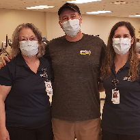 Brad Tippit takes a photograph with his Ops team at TIRR Memorial Hermann.