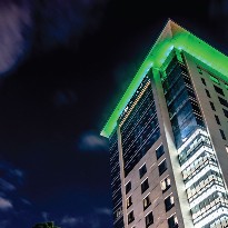 Memorial Hermann tower alight with green.
